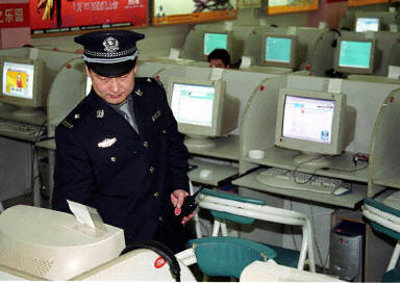 A security official monitors internet usage in a cyber cafe in China.