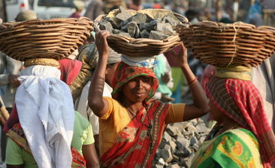 Female Indian labourers carry rocks at an road construction site on the outskirts of Siliguri on March 7, 2008, on the eve of International Womens Day. (Photo: AAP)
