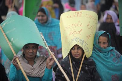 Pakistani human rights activists hold placards at a rally to mark International Women's Day in Islamabad on March 8, 2012. (Photo: AAP)