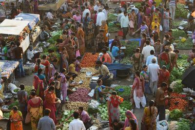 Customers shop for vegetables at a market in Ahmedabad on October 22, 2013. (Photo: AAP)