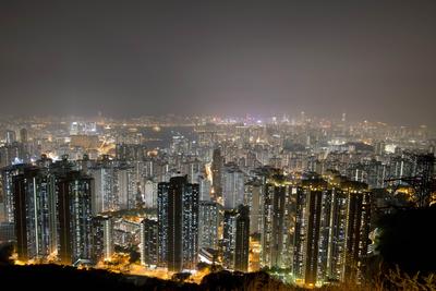 This long exposure picture shows apartment buildings and office blocks clustered tightly together in Hong Kong's Kowloon district on October 28, 2013. (Photo: AAP)