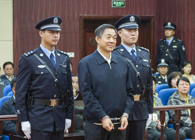 Ousted Chinese politician Bo Xilai stands as the Shandong Provincial Higher People's Court announces the decision of the second trial of Bo, in Jinan, China's Shandong Province. (Photo: AAP)