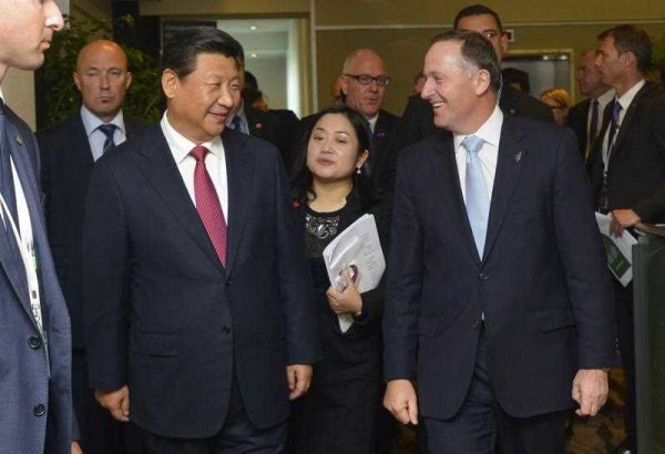 China's President Xi Jinping walks with New Zealand's Prime Minister John Key after attending a meeting with the New Zealand-China Council in Auckland on November 21 2014. (Photo: AAP)