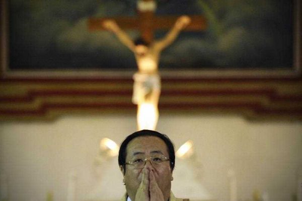 A statue of Jesus on the cross is displayed as Li Shan, the Chinese archbishop, performs the Christmas Eve mass at a Catholic church in Beijing early on December 25, 2012. (Photo: AAP)