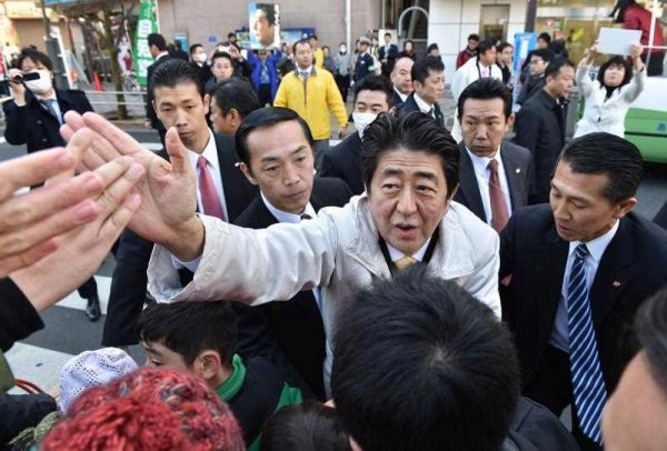 Japan's Prime Minister and ruling Liberal Democratic Party (LDP) leader Shinzo Abe greets supporters after his election campaign speech for the 14 December lower house election. Abe's ruling party is on course for a landslide win in the upcoming general election, opinion polls showed. (Photo: AAP).