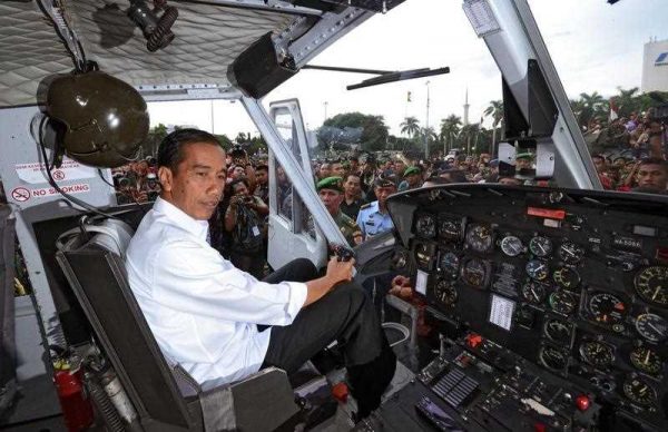 Indonesian President Joko Widodo (Jokowi) in control. President Jokowi inspecting a military helicopter during the Army's exhibition at the National Monument in Jakarta, Indonesia, 17 December 2014. (Photo: AAP).