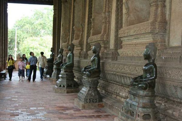 A Laotian family group visiting Wat Ho Phra Keo in the capital, Vientiane. The temple is famed for its Buddhist sculptures. (Photo: AAP)