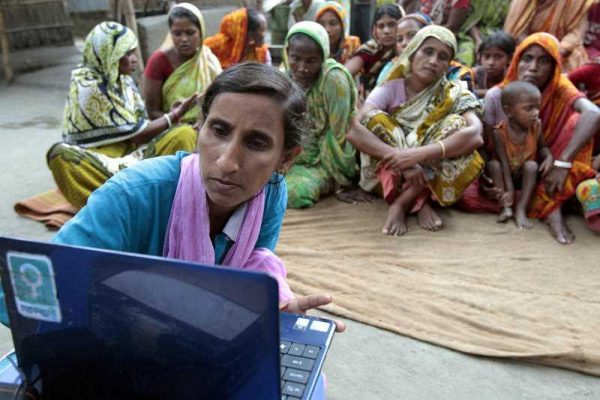 A 29-year-old Bangladeshi woman known as Tattahakallayani or Info Lady shows a 15-minute video played in a laptop at one of their usual weekly meetings at Saghata, a remote impoverished farming village in Gaibandha district, 120 miles (192 kilometers) north of capital Dhaka, Bangladesh. Dozens of “Info Ladies” bike into remote Bangladeshi villages with laptops and Internet connections, helping tens of thousands of people - especially women - get everything from government services to chats with distant loved ones. (Photo: AAP)