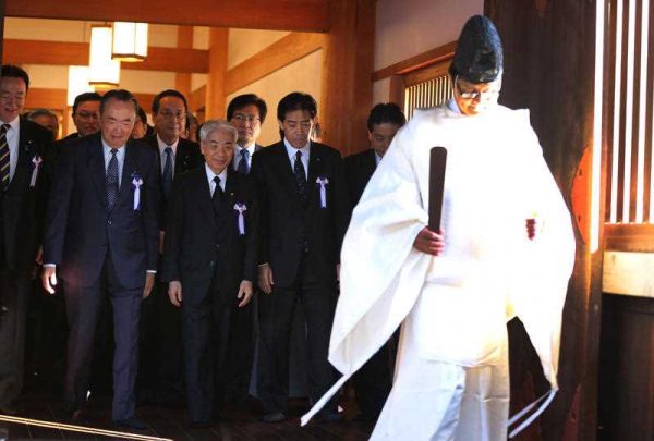 A group of Japanese lawmakers follow a Shinto priest to pay respect for the war dead at Yasukuni Shrine during an annual autumn festival in Tokyo, Friday, Oct. 17, 2014. The shrine enshrines war criminals, including wartime leader Hideki Tojo, among the 2.5 million war dead. (Photo: AAP)