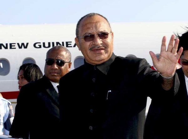 Papua New Guinea's Prime Minister Peter O'Neill waves upon arrival at Bali airport, Indonesia, to attend the Asia-Pacific Economic Cooperation (APEC) forum in 2014. (Photo: AAP).