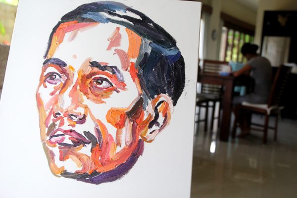 A painting by Bali Nine ringleader Myuran Sukumaran of Indonesian President Jokowi Widodo with words on the back of the painting 'people can change'. (Photo: AAP).