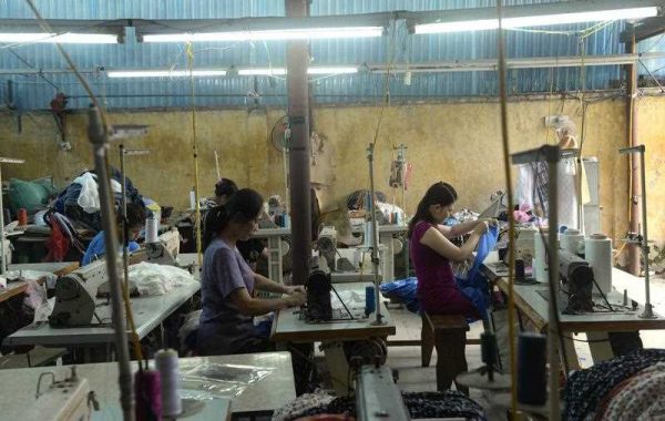 Women work at a small size garment workshop on the outskirds of Hanoi on 2 May 2013. (Photo: AAP)