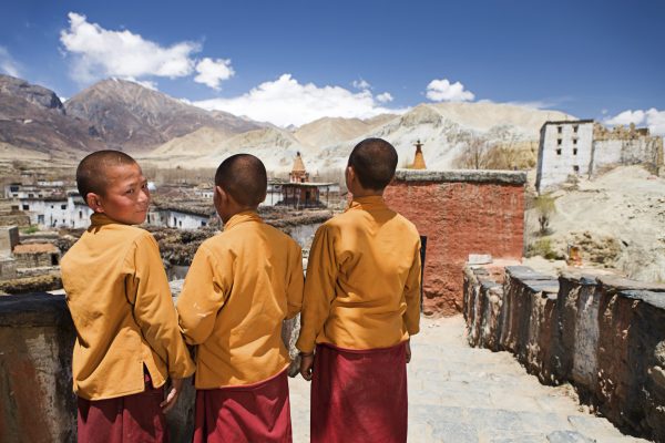 Looking homewards: novices at a Tibetan monastery in Mustang, Nepal. Many Tibetan exiles are banking on reforms in China to resolve the dispute. (Photo: Bartosz Hadyniak, iStock).