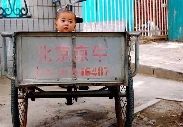 A toddler playing in a rickshaw in Beijing, China, 2007. Around a quarter of China's remarkable economic growth over the past three decades or so was delivered by the dividend from its demographic structure, with a young population augmenting the workforce and lifting output in new jobs. (Photo: Flickr user 'dominiqueb').