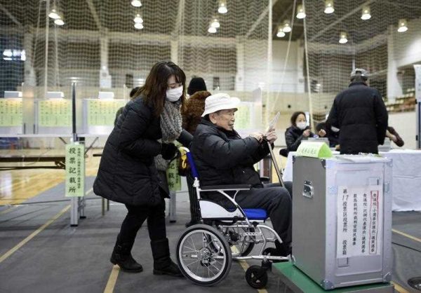 An elderly Japanese man on his way to cast his vote in 2014. The proportion of people aged 65 years old and over is now more than one-quarter of the total population of Japan — proportionally, the largest in the world. (Photo: AAP).