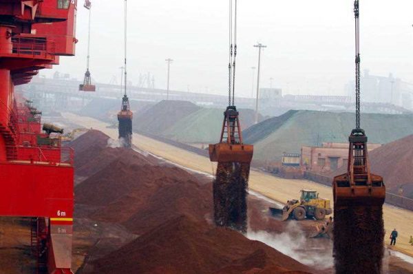 Grab buckets unload imported iron ore on a quay at the Port of Rizhao in east China's Shandong province, 7 February 2015. (Photo: AAP).