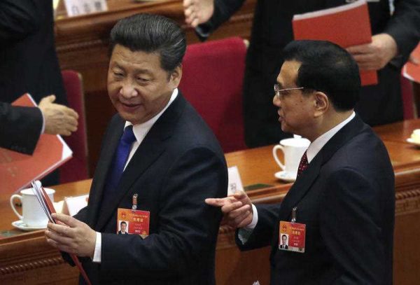 Chinese President Xi Jinping talks with Premier Li Keqiang after the closing session of the annual National People's Congress at the Great Hall of the People in Beijing, 15March 2015. (Photo: AAP).