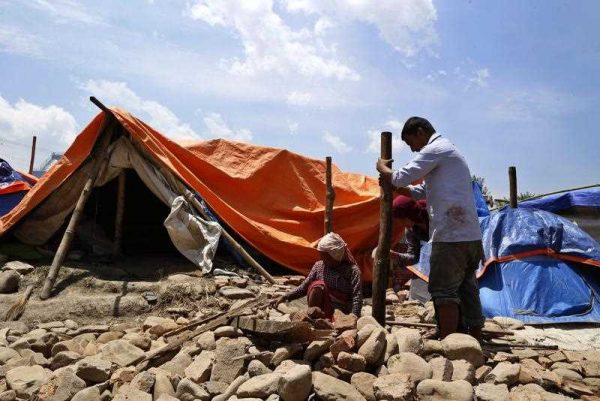 Nepalese earthquake survivors build a makeshift shelter at a devastated area in Bungamati, Nepal, 14 May 2015. (Photo: AAP)