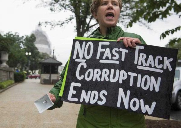 A demonstrator protests against the legislation to give US President Barack Obama fast-track authority to advance trade deals, including the Trans-Pacific Partnership, during a protest march on Capitol Hill in Washington, DC, 21 May 2015. (Photo: AAP)