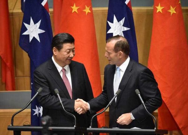 China's President Xi Jinping shakes hands with Australia's Prime Minister Tony Abbott after statements to the media following the signing of a free trade agreement at Parliament House in Canberra on 17 November 2014. (Photo: AAP).