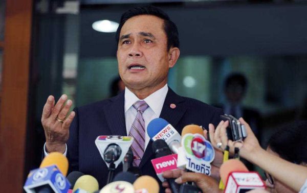 Thai Prime Minister Prayuth Chan-ocha talks to reporters on the anniversary of the military coup at Government house in Bangkok, Thailand. (Photo: AAP)