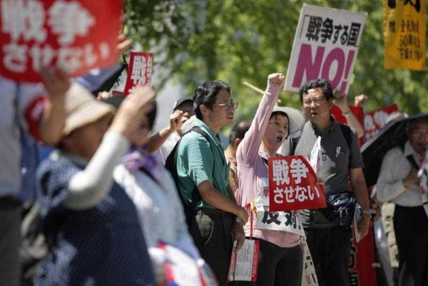 Demonstrators shout while holding banners reading 'No War' during a protest against reforms that would allow Japan to dispatch its Self-Defense Forces overseas, on 26 May 2015. (Photo: AAP)