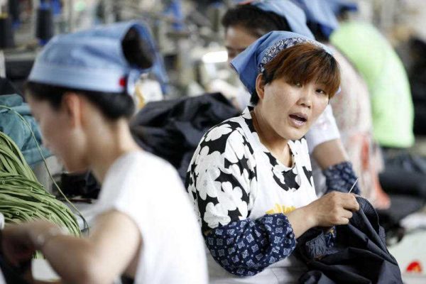 Female Chinese workers sew clothes at a garment factory in Huaibei city, east China's Anhui province, 1 June 2015. Studies suggest that one-quarter of Chinese growth over the past three decades has been the result of its demography. (Photo: AAP)