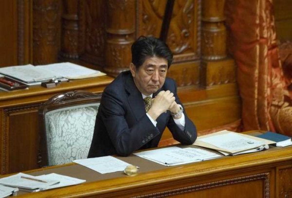 Japan's Prime Minister Shinzo Abe listens to questions at the plenary session of the upper house of parliament in Tokyo on July 27, 2015. The upper house has started debate on controversial security bills which would expand the remit of the country's armed forces. (Photo: AAP)