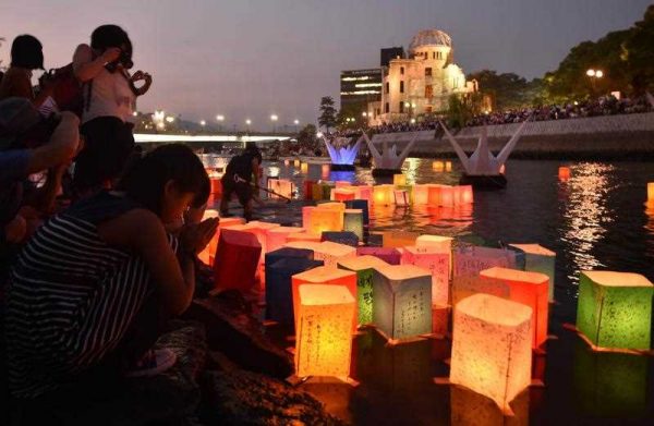Paper lanterns float on the Motoyasu River in front of the Atomic Bomb Dome in Hiroshima on August 6, 2015 (Photo: AAP)