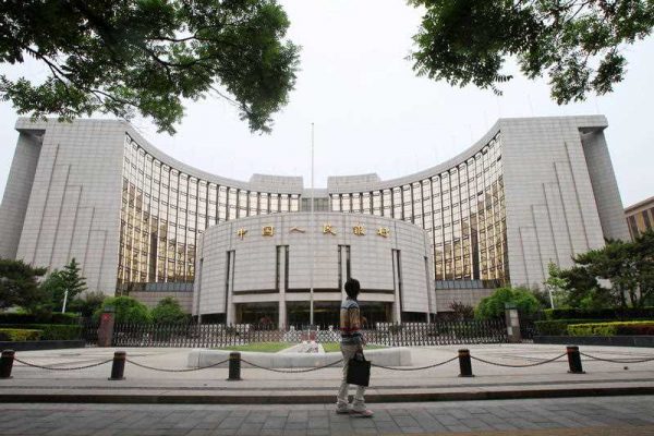 A pedestrian walks past the headquarters and head office of the People's Bank of China (PBOC) in Beijing, China, 10 May 2014. Chinas central bank has completed drafting regulations for an international payment system that would facilitate greater usage of the yuan globally, banking industry sources said on 22 September 2015. (Photo: AAP)