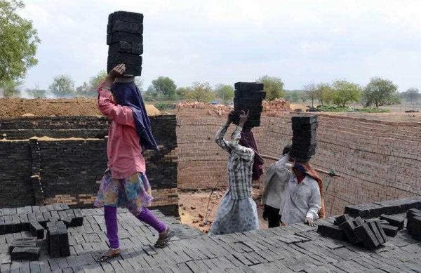 Indian labourers work at a brick manufacturing unit on the outskirts of Hyderabad on 2 March 2015. (Photo: AAP)