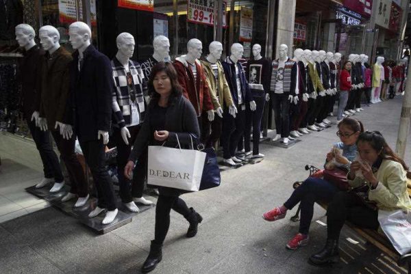 Shoppers walk past a row of mannequins at a shopping mall in Yinchuan in northwestern China's Ningxia Hui autonomous region on 11 October 2015. (Photo: AAP)