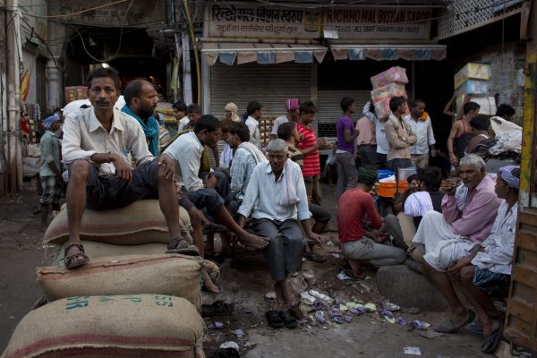 Indian labourers rest as others attend to their daily chores early morning in the Spice Market in New Delhi, India, Thursday, 15 October 2015. (Photo: AAP)