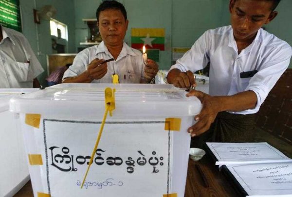 Staff members seal ballot boxes as they prepare for advance voting at a polling station of South Oakkalarpa township, Yangon, Myanmar, 30 October 2015. (Photo: AAP)