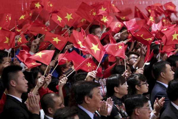 Vietnamese and Chinese communist youths wave flags to welcome Chinese President Xi Jinping and Vietnamese Communist Party General Secretary Nguyen Phu Trong at a meeting in Hanoi, Vietnam, Friday, Nov. 6, 2015. (Photo: AAP)