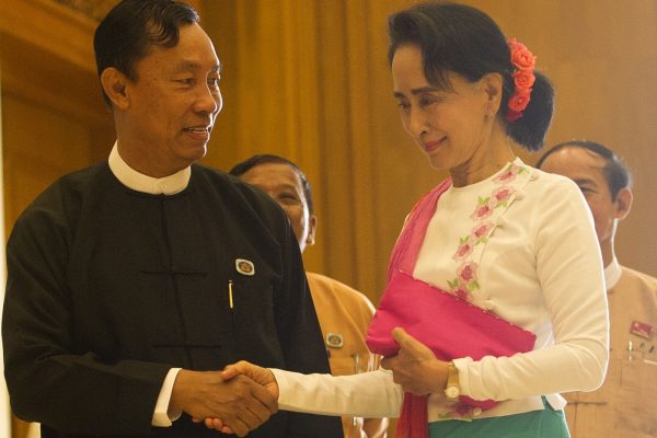 Myanmar's parliamentary speaker Shwe Mann (L) and Chairperson of the National League for Democracy (NLD) Aung San Suu Kyi (R) shake hands before their meeting at Parliament in Naypyidaw on November 19, 2015. Suu Kyi is constitutionally barred from leading the country but has vowed to rule from 