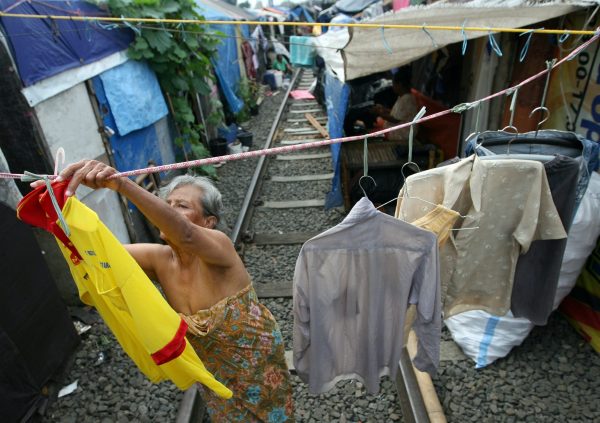 Indonesian womanclothes on the railway near her temporary hut at a slum area in Jakarta, Indonesia (Photo: AAP)