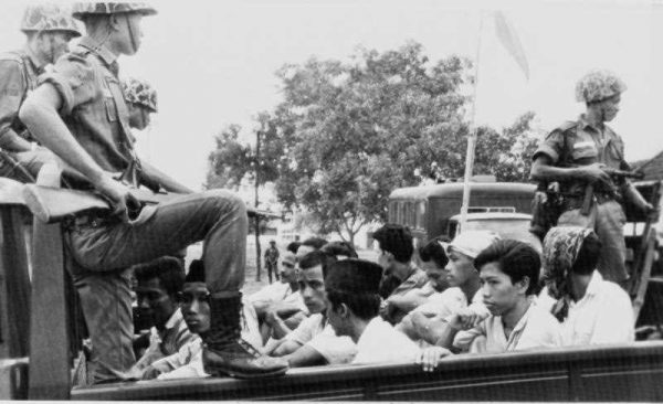 Members of the Youth Wing of the Indonesian Communist Party (Pemuda Rakjat) are guarded by soldiers as they are taken by open truck to prison in Jakarta, October 30 1965. (Photo: AAP).