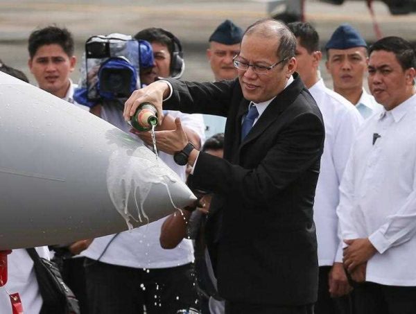 Philippine President Benigno S. Aquino III pours champagne on a FA-50PH aircraft during a joint turn-over and blessing ceremony of newly acquired assets of the Philippine Air Force at the Villamor Air Base in Pasay City, south of Manila, Philippines, 5 December 2015. (Photo: AAP).