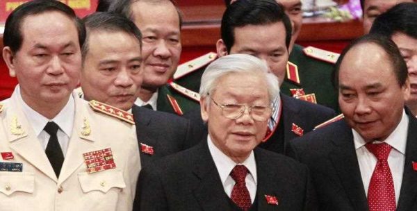 Vietnam's Communist Party General Secretary Nguyen Phu Trong stands next to Deputy Prime Minister Nguyen Xuan Phuc and Public Security Minister Tran Dai Quang while posing for a photo at the Closing Ceremony of the 12th National Congress of Vietnam Communist Party in Hanoi, Vietnam. (Photo: AAP)