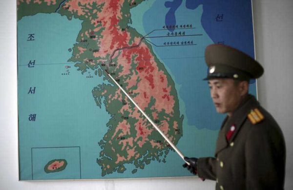 Korean People's Army Lt. Col. Nam Dong Ho points to a map showing the line which separates the two Koreas in Panmunjom at the Demilitarized Zone (DMZ) on 22 February 2016, in Panmunjom, North Korea. (Photo: AAP).