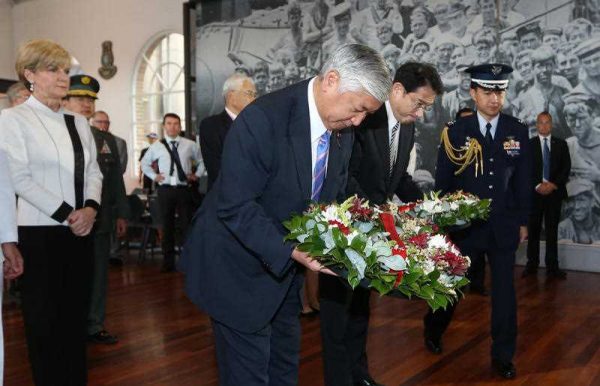 Accompanied by Australia's Minister for Foreign Affairs Julie Bishop, Japan's Minister of Defense Gen Nakatani, and Minister for Foreign Affairs Fumio Kishida, pay their respects and lay wreaths at a World War 2 Japanese midget submarine display during a visit to the Royal Australian Navy Heritage Centre in Sydney, Sunday, 22 November 2015. (Photo: AAP).