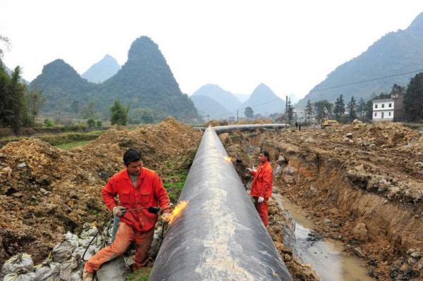 Workers weld a pipeline at a construction site of the Myanmar–China natural gas pipeline in Laibin city, south China's Guangxi Zhuang Autonomous Region, 25 January 2013. (Photo: AAP).