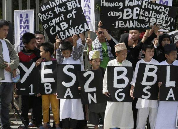 Filipino Muslims display placards during a rally at the Philippine Senate to coincide with the hearing at the Upper House on the passage of the Bangsamoro Basic Law (BBL) which the Philippine Government and Muslim rebels have entered into that would establish an autonomous region in southern Philippines Monday, 25 May 2015 in Manila, Philippines.