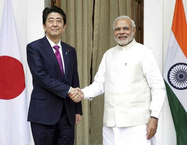 Indian Prime Minister Narendra Modi and his Japanese counterpart Shinzo Abe shake hands prior to their meeting in New Delhi, India, 12 December 2015. (Photo: AAP).