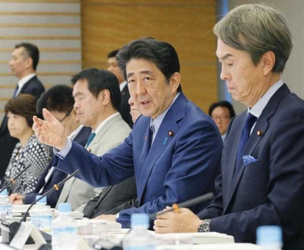 Japanese Prime Minister Shinzo Abe attends a joint meeting of the Council on Economic and Fiscal Policy and the Industrial Competitiveness Council at the prime minister's in Tokyo on 2 June 2016. The government endorsed a plan the same day to enhance social security measures aimed at tackling Japan's aging population, amid uncertainty over funding resources following the delay of a planned sales tax hike.