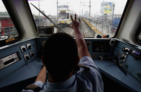 A train operator on Southeast Asia’s oldest light rail transit network in Manila, Philippines, 11 October 2013. (Photo: Reuters).