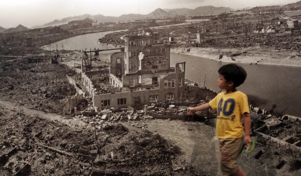 A boy looks at a photograph showing Hiroshima city after the 1945 atomic bombing, at the Hiroshima Peace Memorial Museum, Japan, 6 August 2007. (Photo: Reuters)