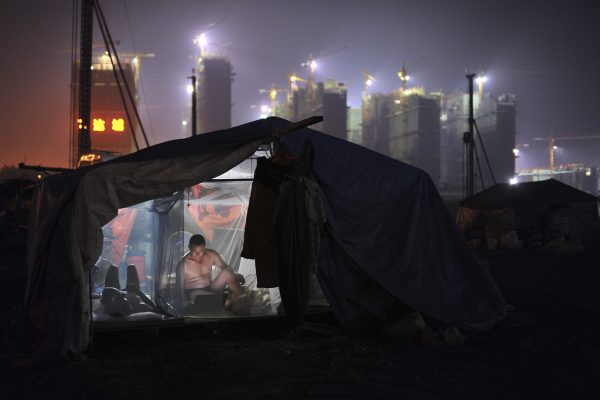 A worker inside his dormitory near a residential construction site in Hefei, Anhui province. (Photo: Reuters/Stringer).