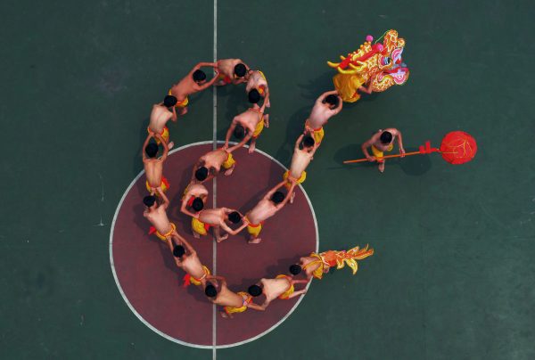 Students learn to perform a traditional dragon dance under the instruction of a local Chinese artist. (Photo: Reuters).